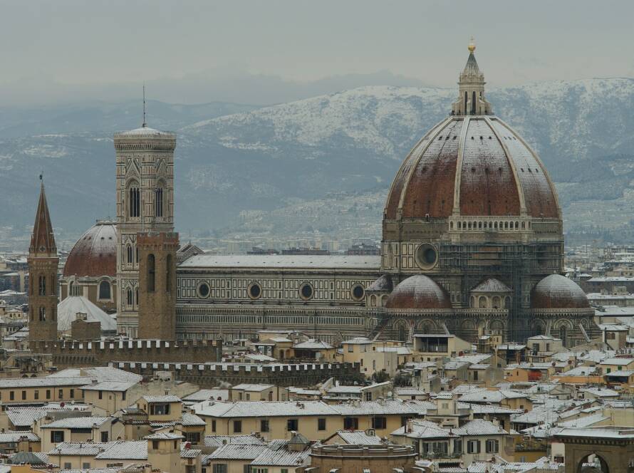Florence Cathedral and the hills covered in snow in winter