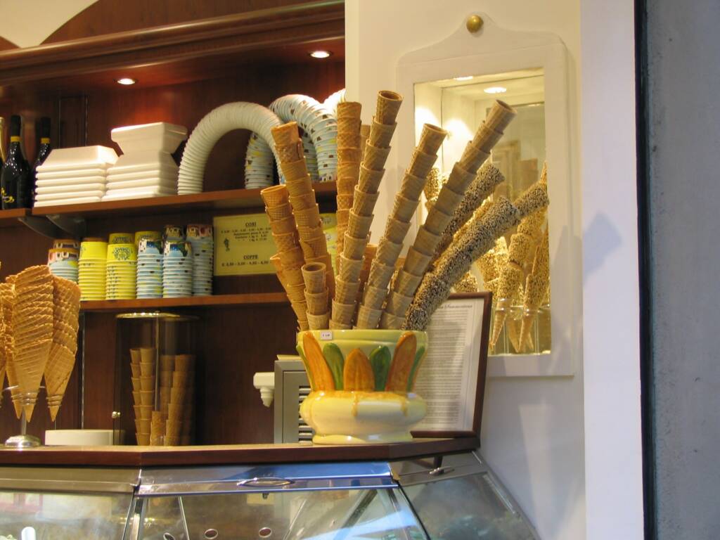 Gelato cones and artisan gelato in a Florence gelateria