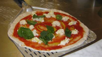 Neapolitan pizza margherita with basil and mozzarella
